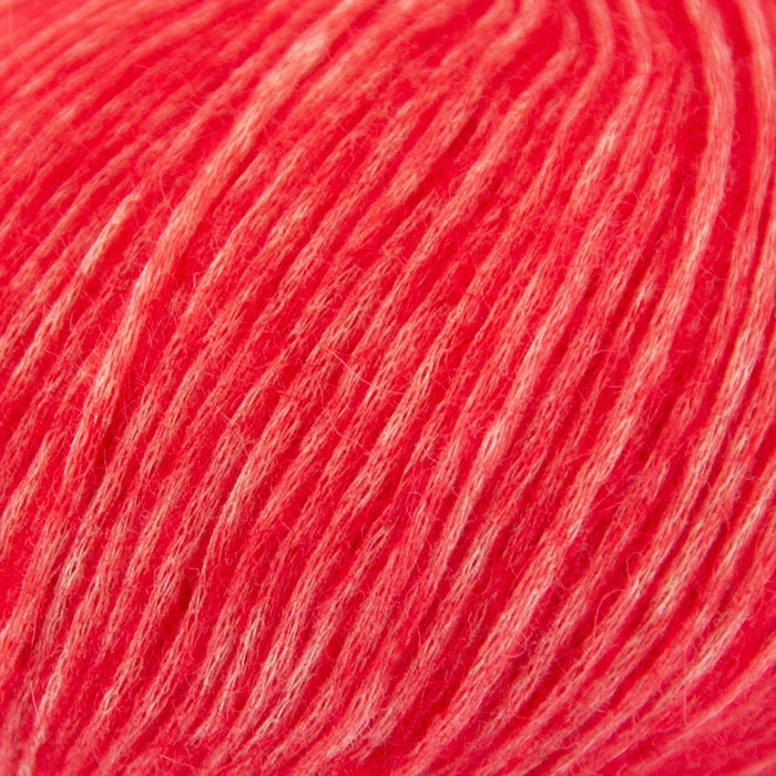 Close-up view of Chaska Wara DK yarn in vibrant red for knitting projects.