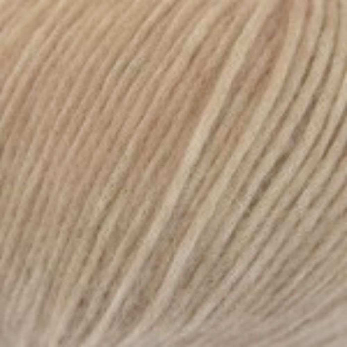 Close-up of Chaska Wara DK yarn in cream color, featured in the Simple Triangle Shawl Knit Kit.