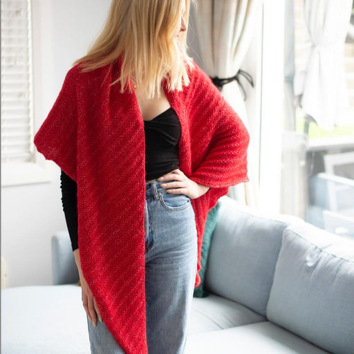 Woman wearing a red Simple Triangle Shawl; cozy knit kit accessory.