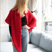 Woman wearing a red Simple Triangle Shawl; cozy knit kit accessory.