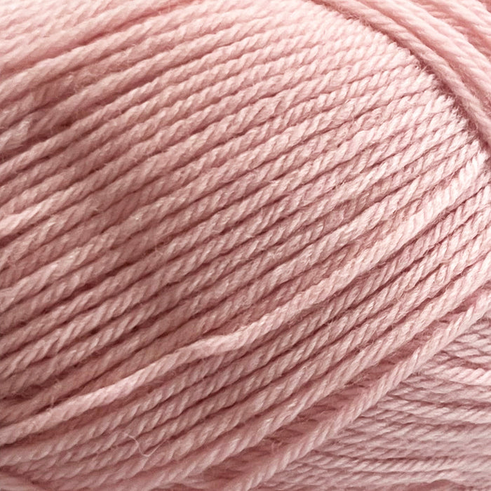 Soft pink 4ply New Zealand Merino wool yarn for textured baby jacket knitting kit.