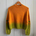 Striped jumper knit kit featuring cozy top-down style in vibrant orange and green hues.
