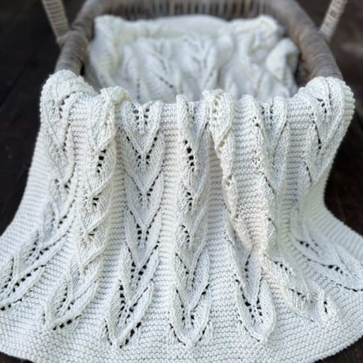 Cream Willow Leaves blanket with repeating lace leaf panels and garter-stitch borders