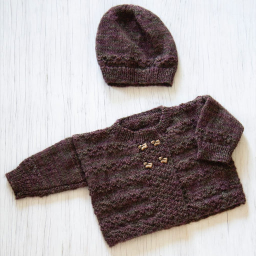 Baby cardigan and hat knitting pattern in Naturally Omana Print 4ply yarn, featuring textured stitch and button detail.