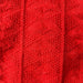 Texture pattern on red Esther Sweater Junior knitting pattern.