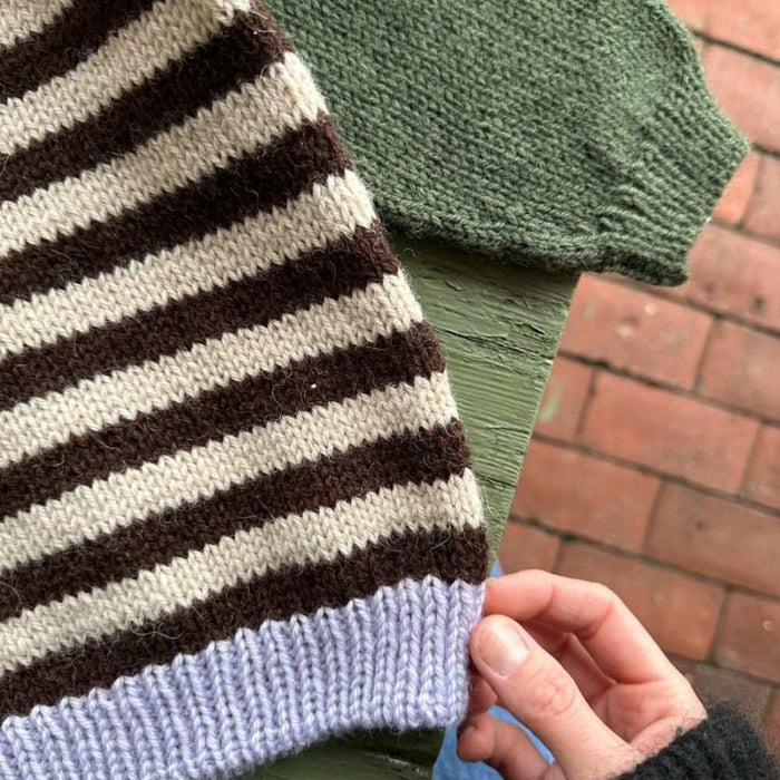 Holger Sweater Knitting Pattern by PetiteKnit featuring striped stockinette stitch and solid color details.