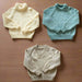 Children's jumper knitting patterns with raglan sleeves and different necklines in pastel colors.