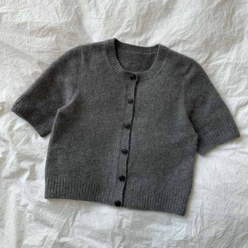 PetiteKnit Maggie Cardigan knitting pattern showcasing a short-sleeve, button-up design in gray.