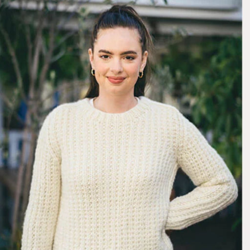 Woman wearing a cream rib saddle shoulder sweater, created using the Crucci knitting pattern CRU2113.