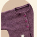 Sideways knitted baby cardigan in purple, featuring garter stitch and buttoned front.