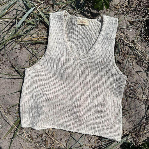 Alice Top Knitting Pattern by PetiteKnit, V-neck, sleeveless design on sandy background.