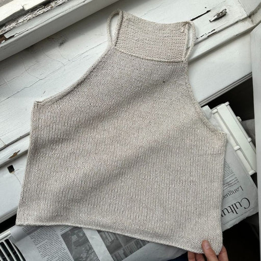 Knitted Audrey Top laid flat, showcasing stockinette stitch and i-cord straps from PetiteKnit.