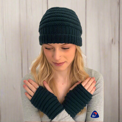 Knitted ribbed beanie and fingerless mittens set in dark yarn for a beginner-friendly knitting pattern.