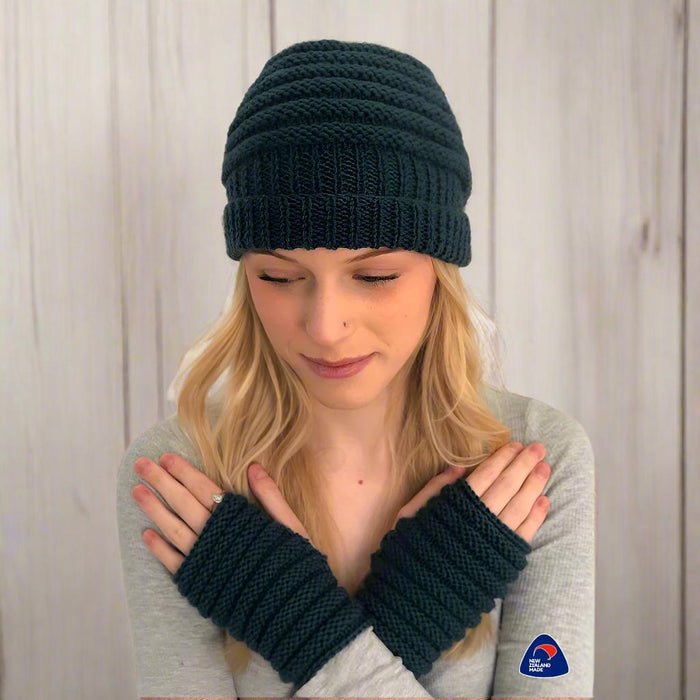 Knitted ribbed beanie and fingerless mittens set in dark yarn for a beginner-friendly knitting pattern.