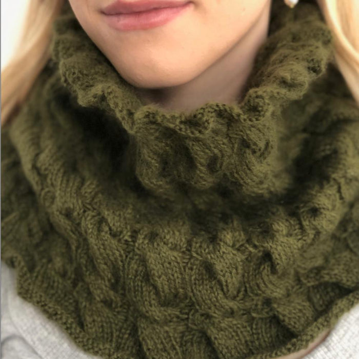 Cabled cowl knitting pattern in green Puray Fine DK yarn.