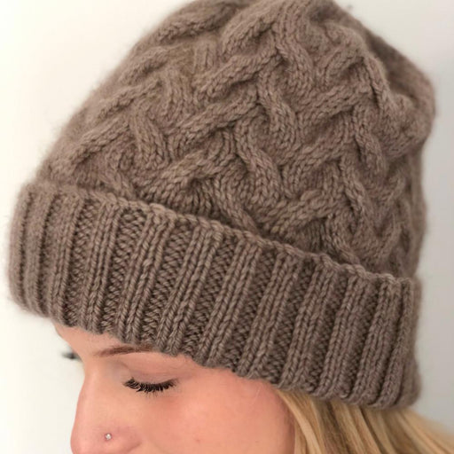 Cabled beanie with intricate design, knitted in Possum Fusion DK yarn for warmth and style.