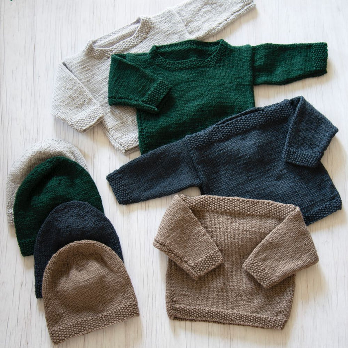 Knitted baby sweaters and hats in various colors made with Naturally Classic DK/8ply yarn, featuring crew and boat neck designs.