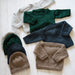 Knitted baby sweaters and hats in various colors made with Naturally Classic DK/8ply yarn, featuring crew and boat neck designs.