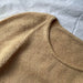 Cumulus Tee O Neck knitting pattern by PetiteKnit, showcasing detailed stockinette stitch and round neck finish.