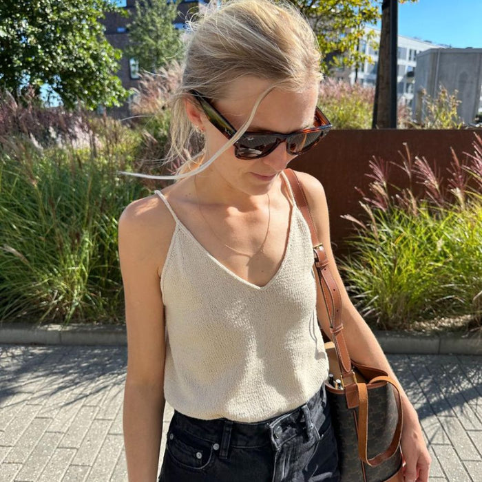 Cumulus Top by PetiteKnit, sleeveless V-neck knit, worn outdoors in sunlight.