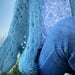 Cozy blue eyelet knit cardigan with three-quarter sleeves and relaxed fit.