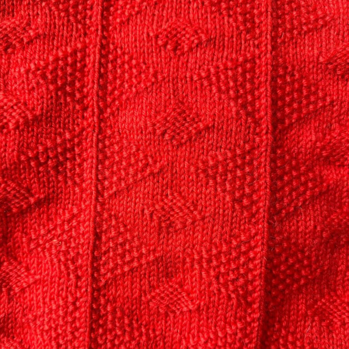 Texture pattern on red Esther Sweater Junior knitting pattern.