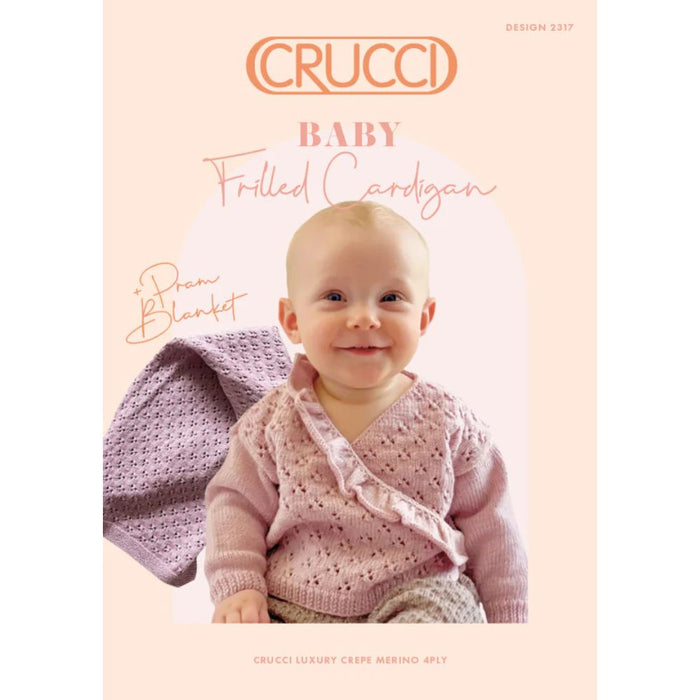 Baby wearing hand-knit frilled cardigan, with matching pram blanket, from Crucci Merino Crepe pattern design 2317.