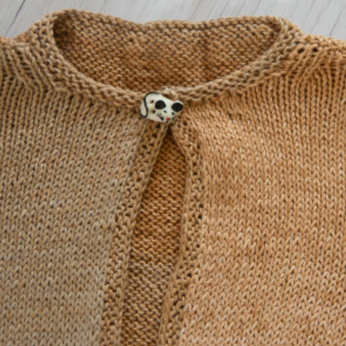 Girls' cardigan knitting pattern with garter stitch borders and button closure.