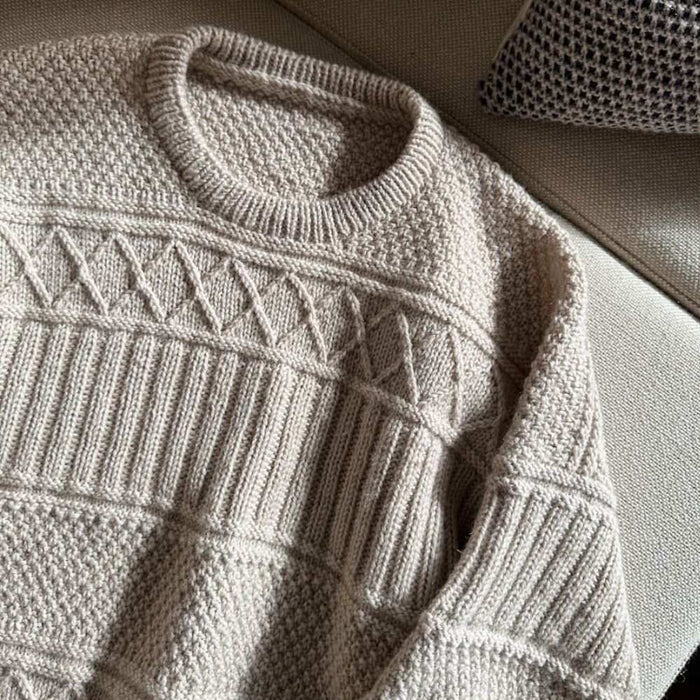 Ingrid Sweater Man knitting pattern by PetiteKnit showing textured design and ribbed neck.