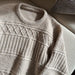 Ingrid Sweater Man knitting pattern by PetiteKnit showing textured design and ribbed neck.