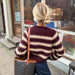 PetiteKnit Key Cardigan with two-color stranded stripe pattern, worn outdoors.