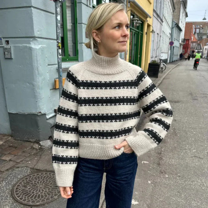 Cozy striped sweater knit with PetiteKnit pattern, featuring raglan sleeves and ribbed edges.