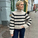 Cozy striped sweater knit with PetiteKnit pattern, featuring raglan sleeves and ribbed edges.