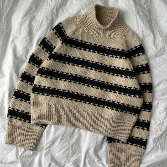 Key Sweater Knitting Pattern by PetiteKnit in beige and black stripes, featuring raglan sleeves and ribbed edges.