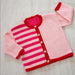 Kids cardigan in pink and red stripes with star buttons, knitted in Sesia Bio Sunny DK/8ply yarn.