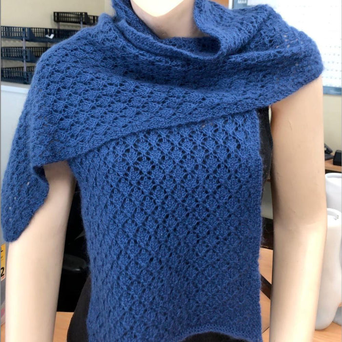 Elegant blue lacey scarf showcasing a delicate lace pattern, knitted using Puray Fine DK for a sophisticated touch.