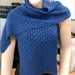 Elegant blue lacey scarf showcasing a delicate lace pattern, knitted using Puray Fine DK for a sophisticated touch.