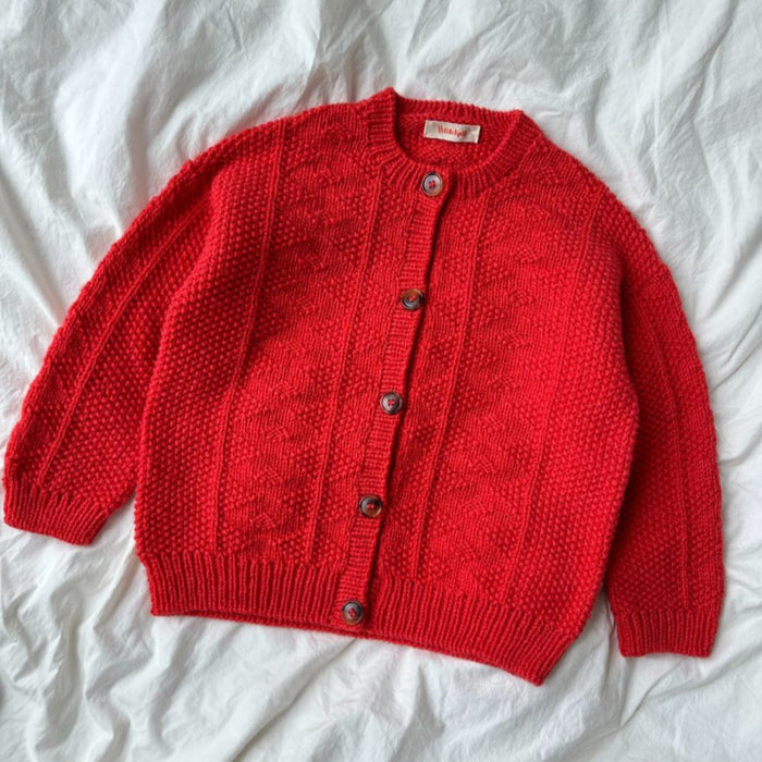 Red knitted jacket with button closure, featuring a textured pattern, designed by PetiteKnit.