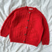 Red knitted jacket with button closure, featuring a textured pattern, designed by PetiteKnit.