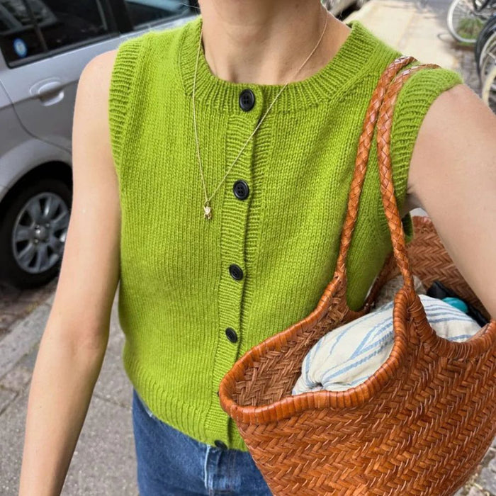 Maggie Vest Knitting Pattern by PetiteKnit in vibrant green with button details and ribbed armhole edges.
