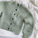Novice Cardigan Mini Chunky Edition by PetiteKnit, knitted green cardigan with black buttons, ribbed edges, and round yoke.