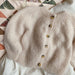 PetiteKnit Novice Cardigan Mini Mohair Edition displayed on fabric background.
