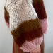 Knitted Piper Jacket cardigan with striped mohair pattern in multicolored shades, showcasing its cozy texture and stylish design.