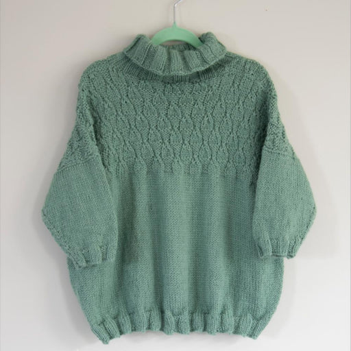 Children's poncho-jumper with textured pattern and ribbed sleeves, knitted in Muhu DK/8ply for ages 2-8.