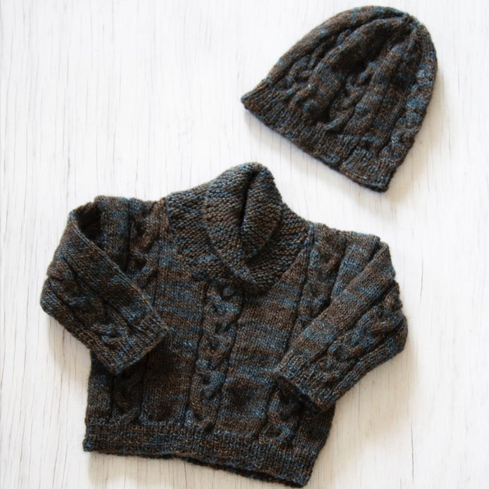 Shawl collar sweater and hat knitting pattern in Naturally Omana Print 4ply, featuring cable details for children aged 6 months to 3 years.