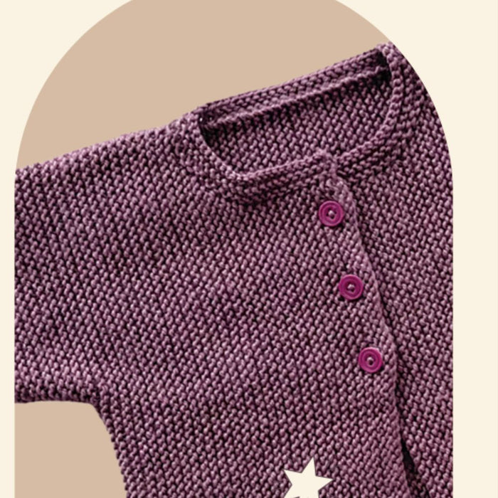 Sideways knitted baby cardigan in purple, featuring garter stitch and buttoned front.