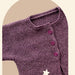 Sideways knitted baby cardigan in purple, featuring garter stitch and buttoned front.