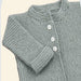 Knitted baby cardigan in garter stitch with buttoned front and fold-back cuffs.