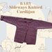 Sideways knitted baby cardigan knitting pattern in purple, featuring buttoned front and garter stitch.