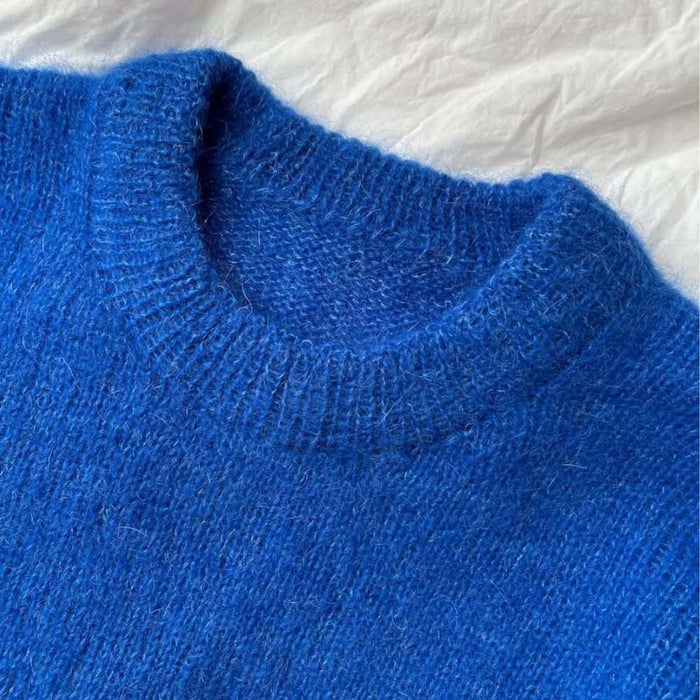 PetiteKnit Stockholm Sweater Junior in blue stockinette stitch with ribbed collar.